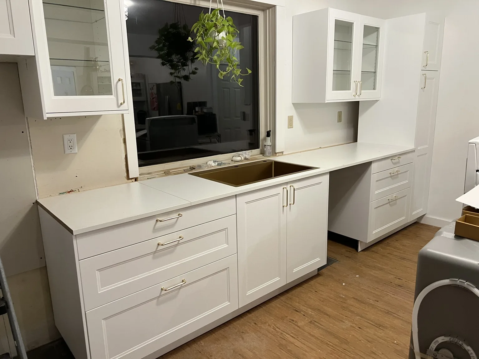 Classic white shaker IKEA kitchen with gold hardware and countertops